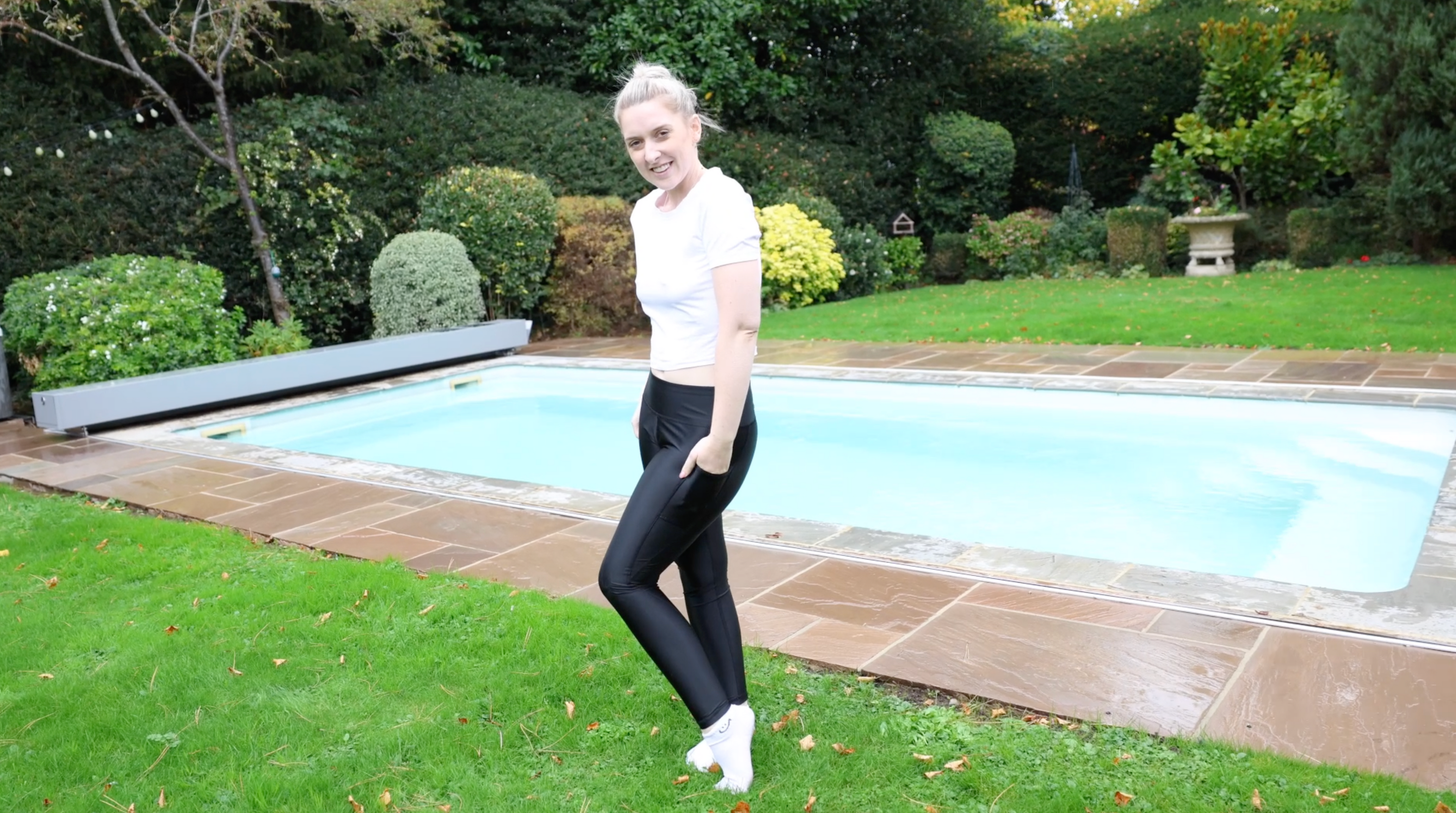White T-Shirt and Shiny Black Leggings With Socks In Pool