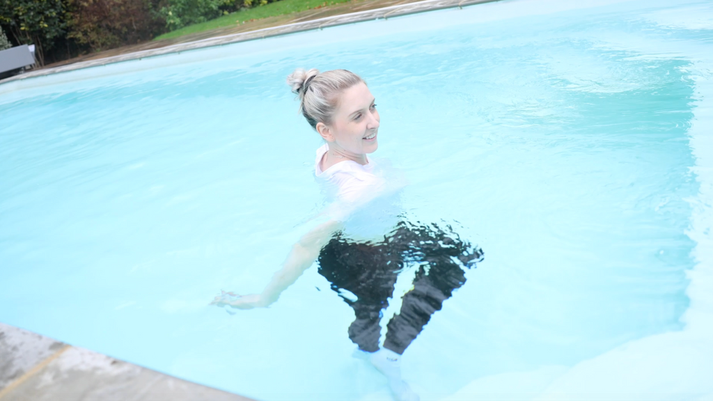 White T-Shirt and Shiny Black Leggings With Socks In Pool