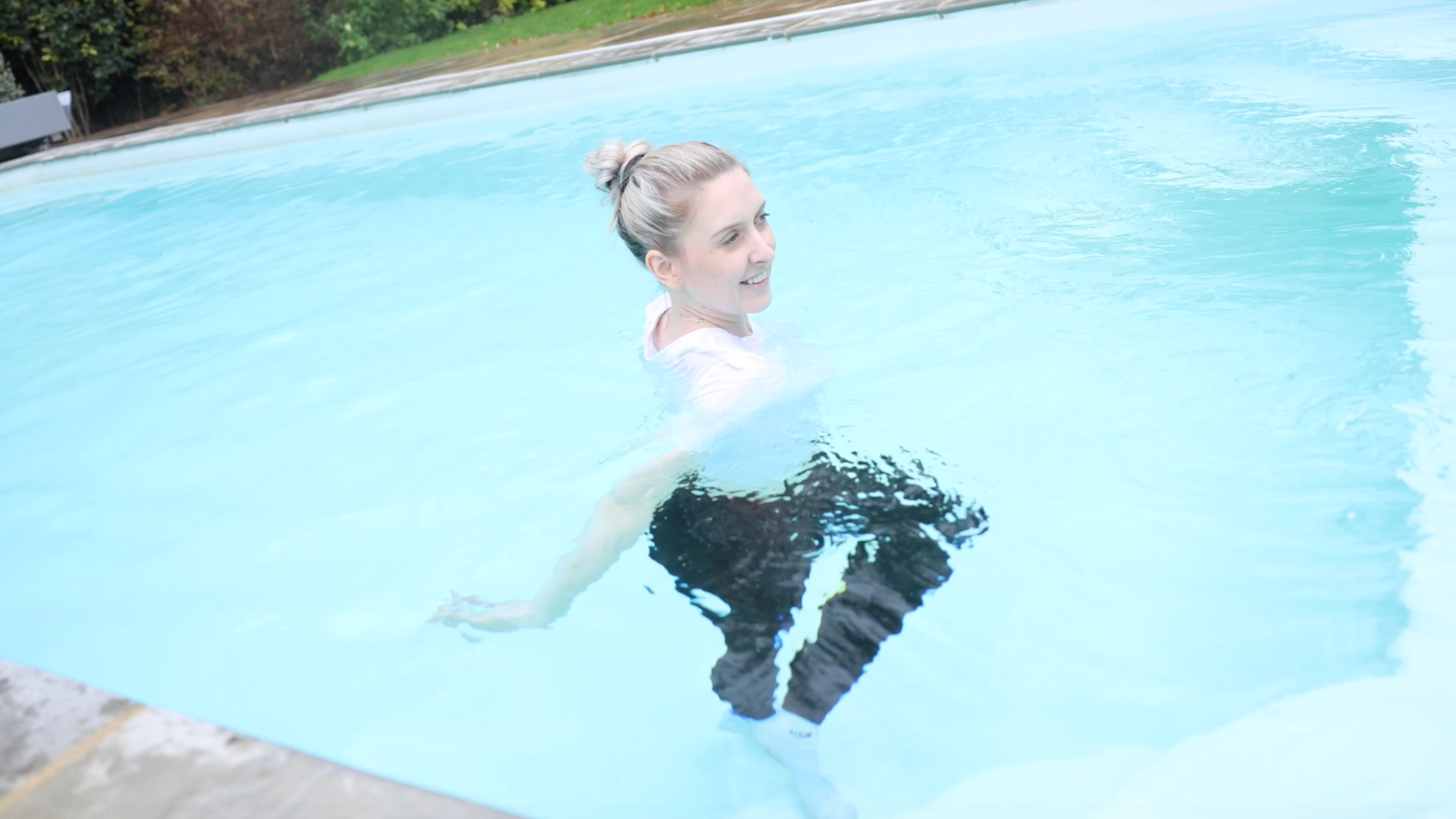 White T-Shirt and Shiny Black Leggings With Socks In Pool