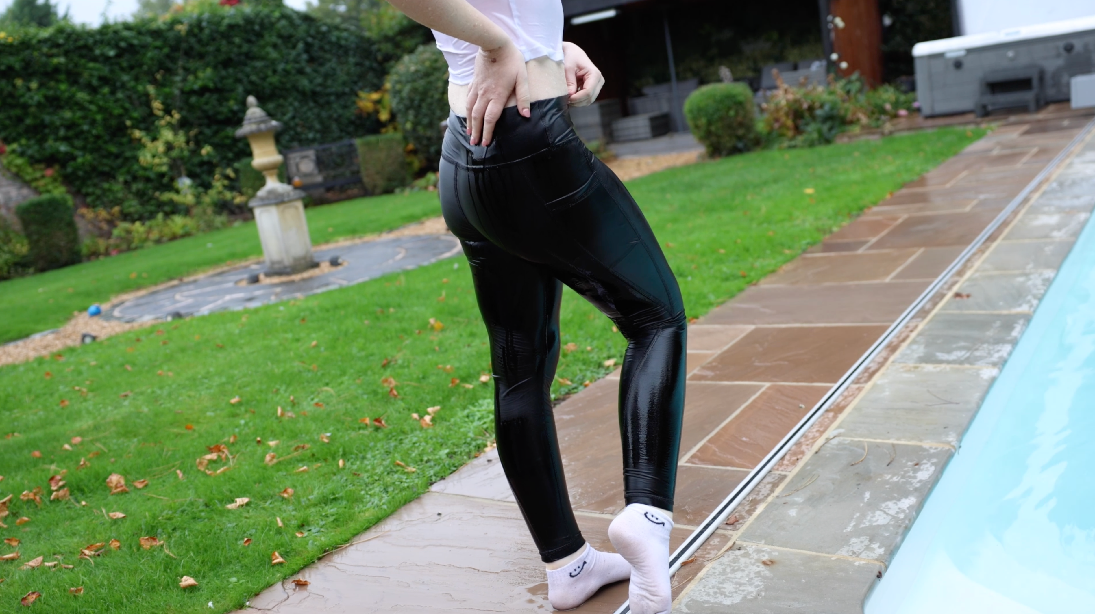 White T-Shirt and Shiny Black Leggings With Socks In Pool